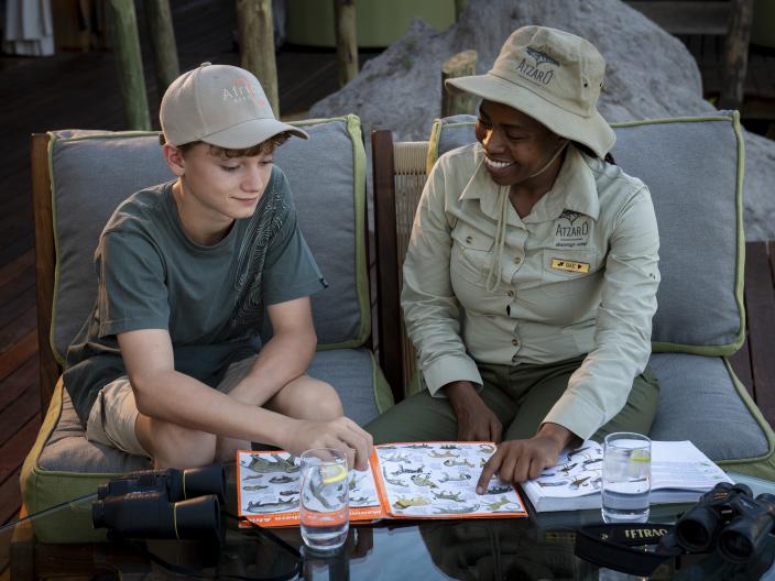 child and tour guide looking through book