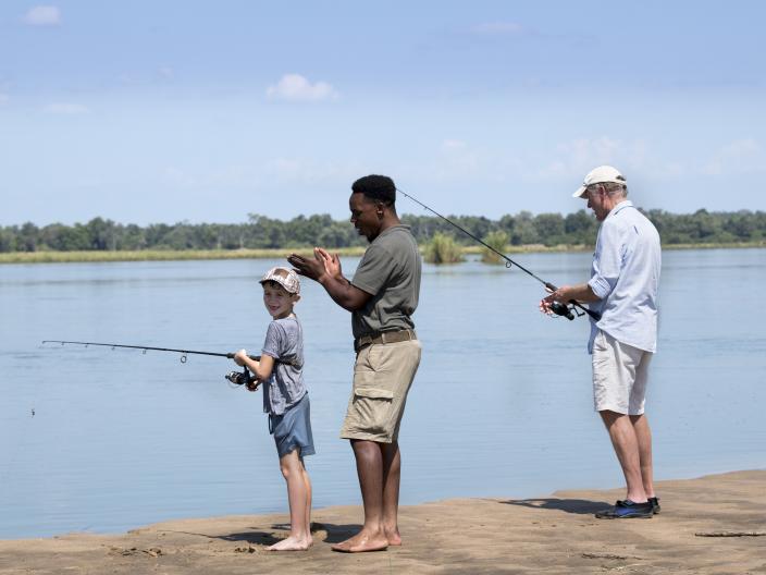 3 men fishing on shore