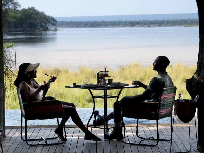 Couple eating outside next to water