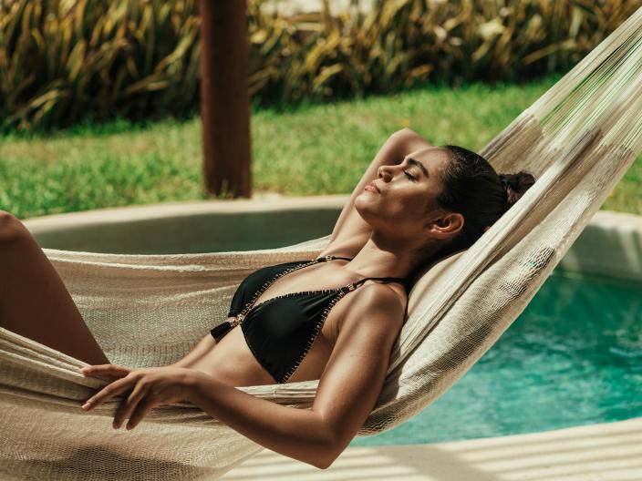 a closeup of a woman relaxing on a hammock 