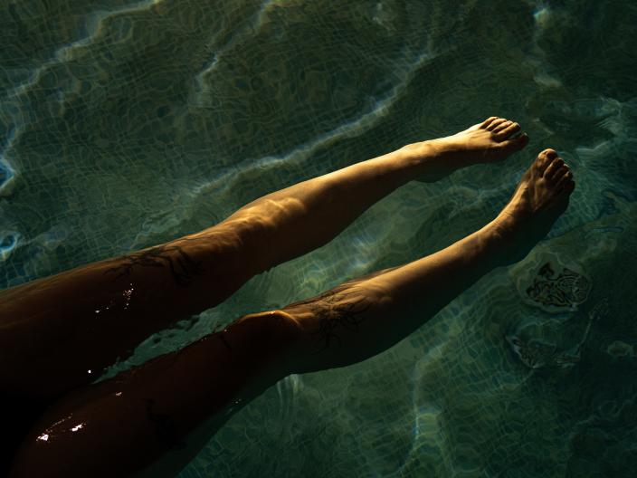 A woman with her legs in the pool