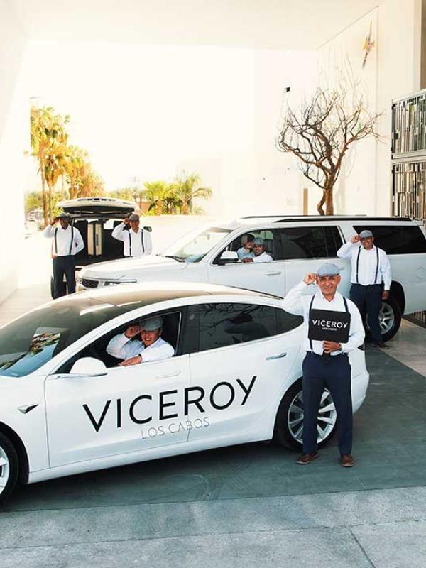drivers stand in front of viceroy branded white vehicles