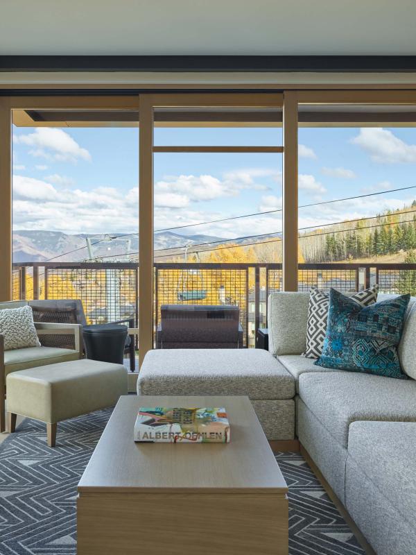 interior view of living room with tv, fireplace, and balcony