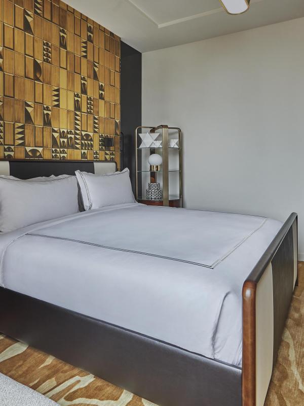 Bedroom with queen bed and desk area
