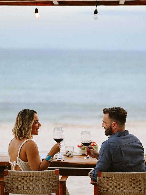 A couple enjoying dinner on the beach