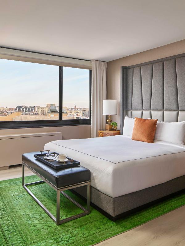 bedroom with king bed and a green rug