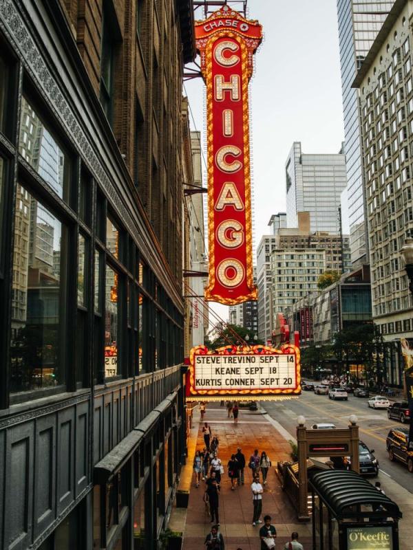 A large vintage neon sign that reads "Chicago" in downtown Chicago
