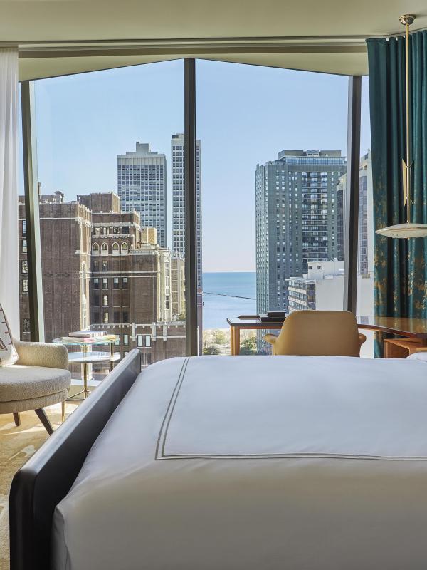 A room at Viceroy Chicago with floor to ceiling windows and a beautiful view of the city