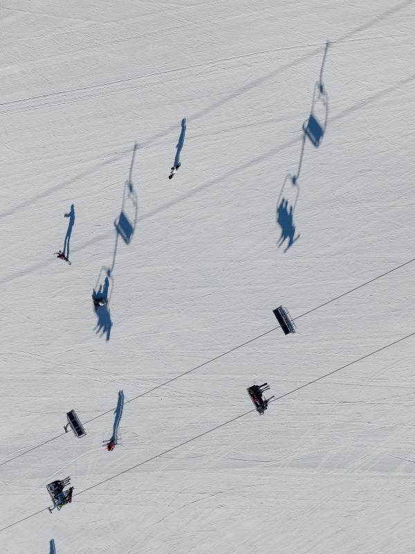 Shadows cast on the snow from a ski lift overhead at Viceroy Snowmass