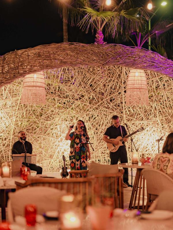 A band performing music to patron at Awacate at Los Cabos