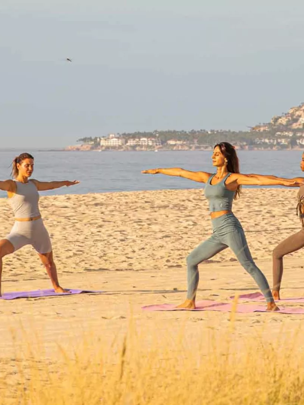 3 women doing yoga on the beach at Viceroy Los Cabos