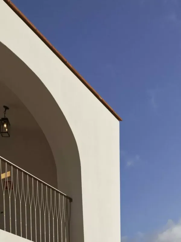A balcony looking out on a bright blue sky