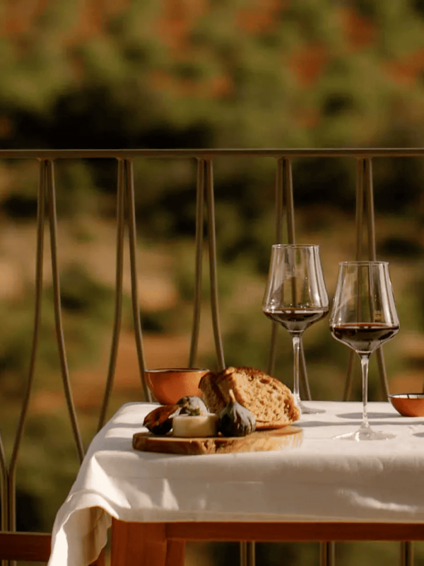 A table with a wine bottle , cheese and bread at Ombria Algarve