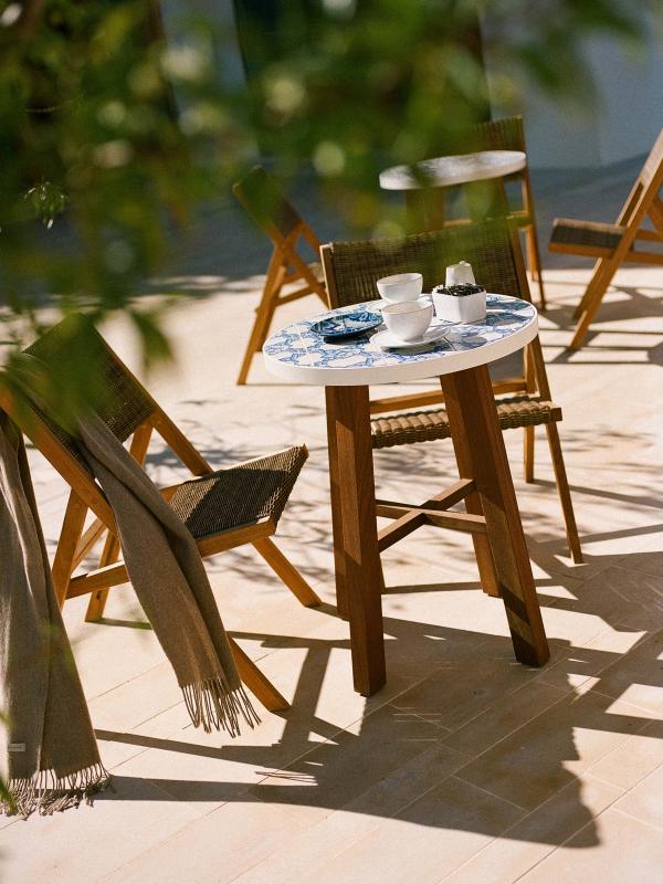 A patio table with espresso cups in the sun at Cafe Central