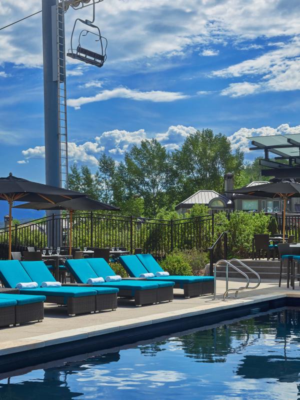 The pool and lounge area at Viceroy Snowmass on a sunny day.
