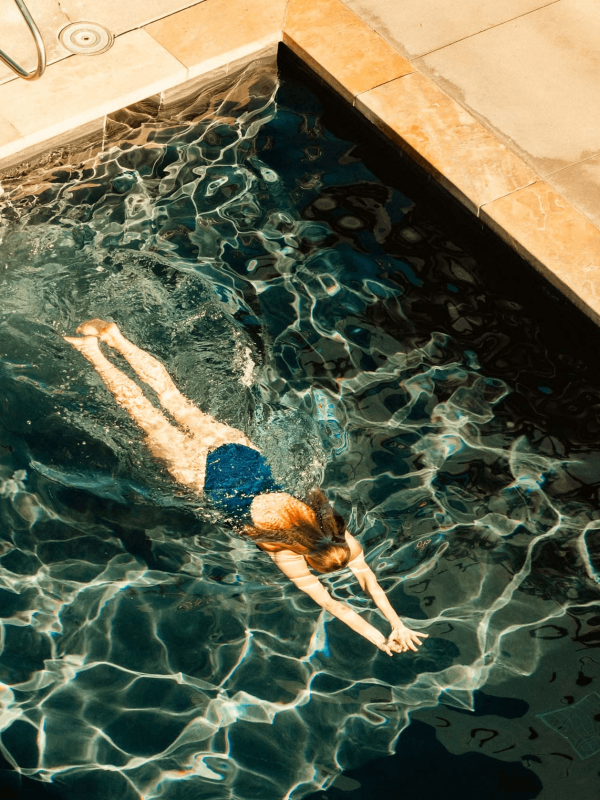 A woman swimming in a pool at Viceroy Snowmass