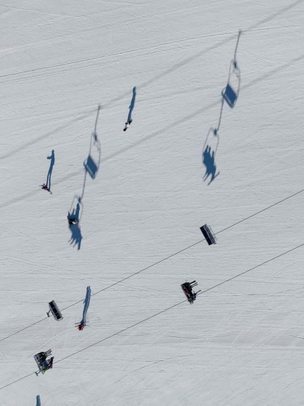 Shadows cast on the snow from a ski lift overhead at Viceroy Snowmass