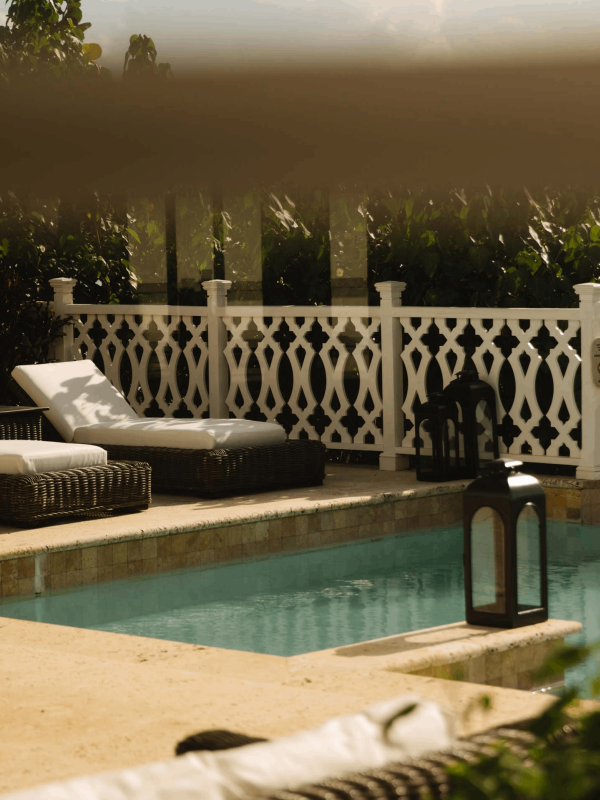 Two lounge recliners by the pool at Viceroy Sugar Beach
