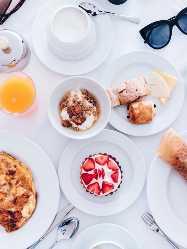 A spread of breakfast food and drinks on a table at Viceroy Zena Washington DC
