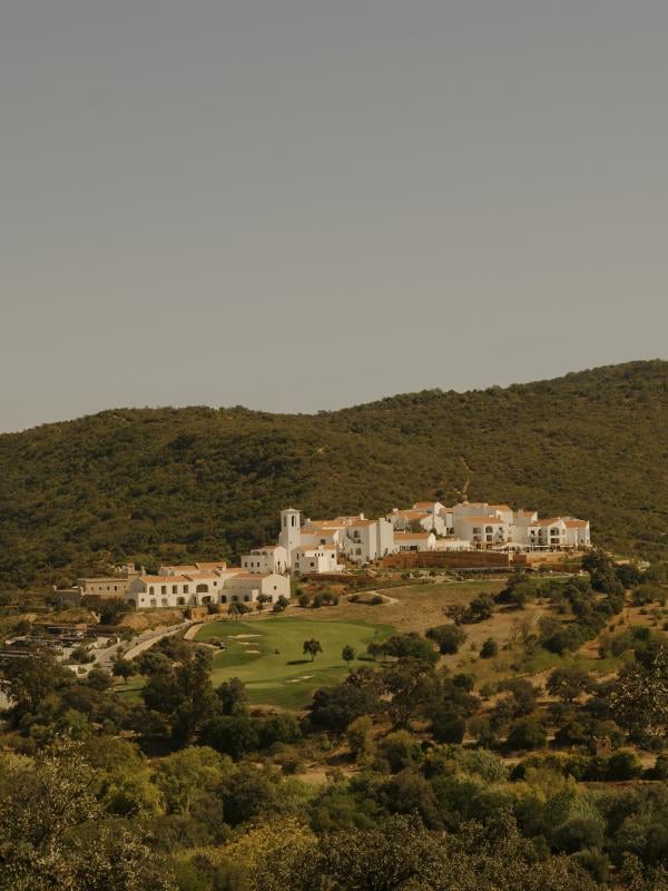 An exterior view of the Ombria Algarve int eh hill surrounded by trees