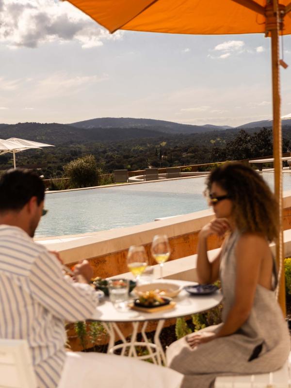 A couple enjoying a lunch on a sunny patio