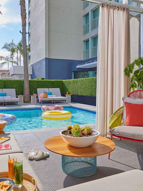 The view of the pool from a cabana filled with snacks at Viceroy Santa Monica