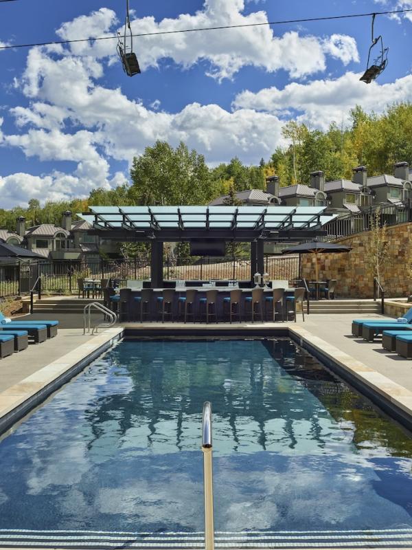 viceroy snomass pool with pool deck, and chairs
