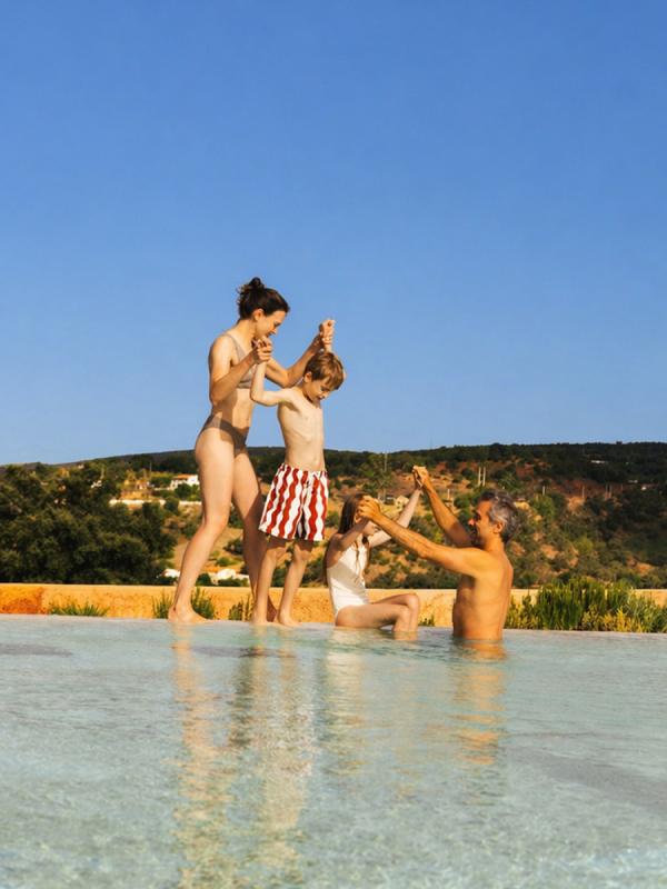 family playing at the pool