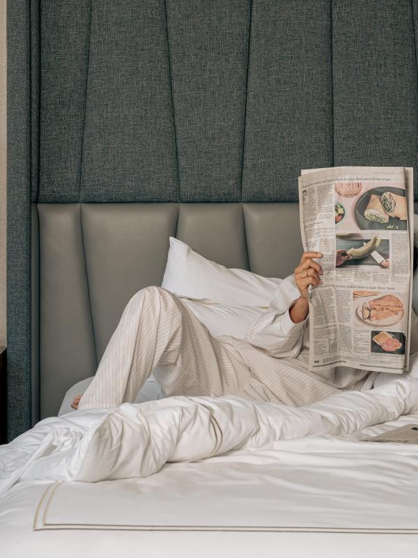Guestroom with guest reading the newspaper