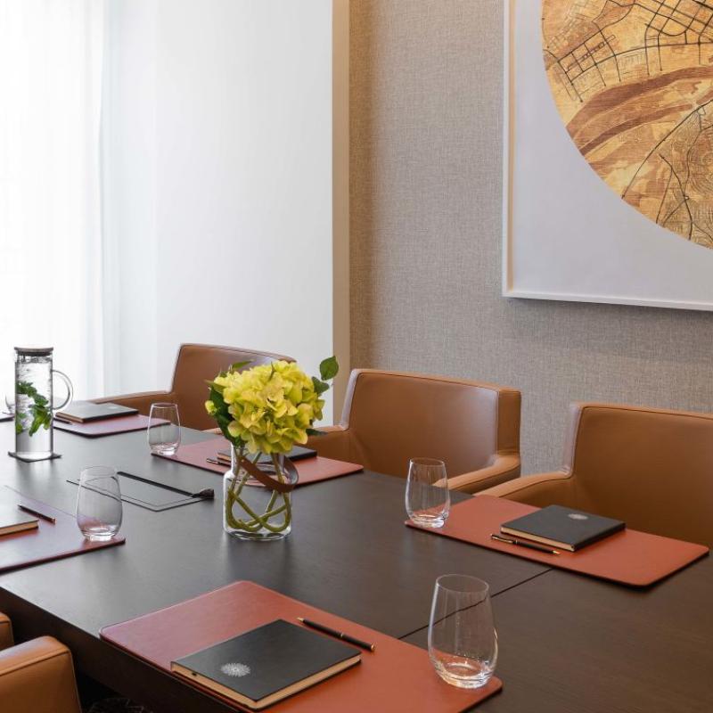 The Sky Boardroom at Viceroy Kopaonik Serbia, with chairs, meeting table and art piece on the wall
