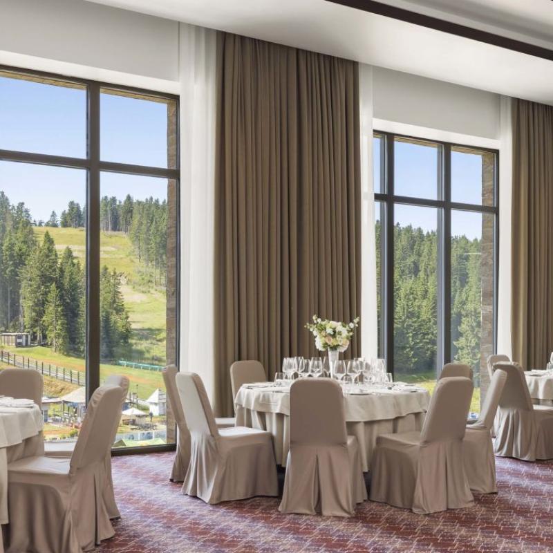 The Aero room at Viceroy Kopaonik Serbia, with windows looking out on a ski slope in summer time