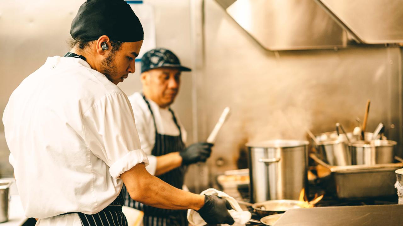 Two chefs working in a kitchen