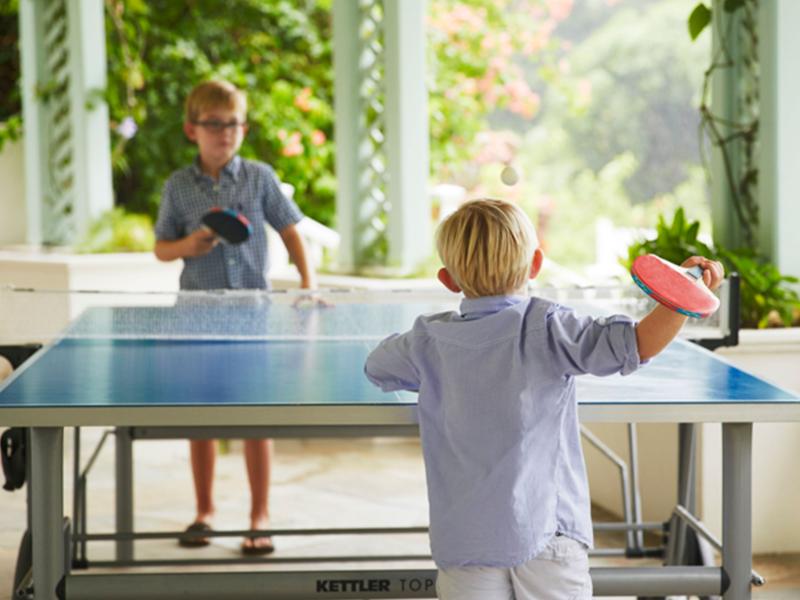 two children play table tennis