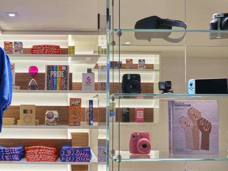 glass shelves of retail items and attire
