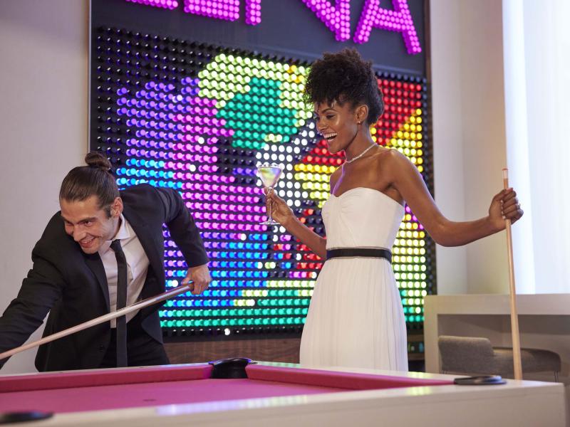 bride and groom play a game of pool