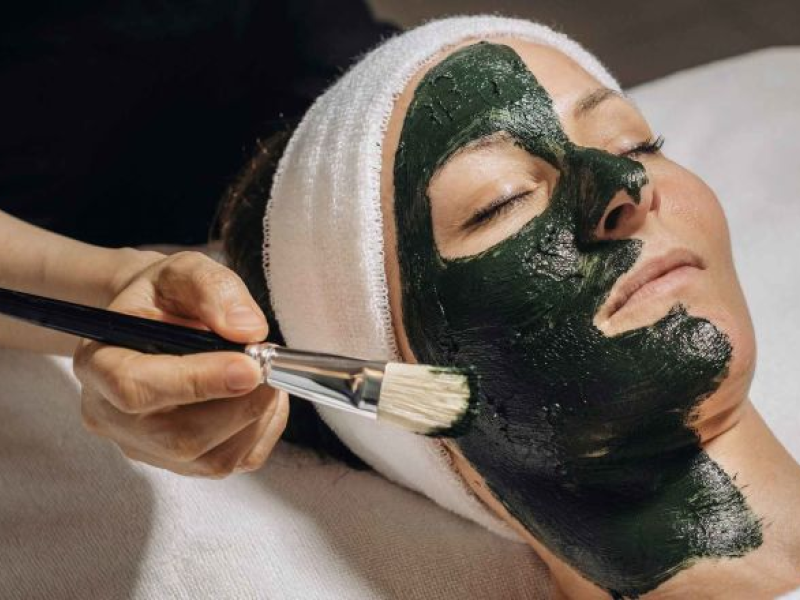 A person geting a facial treatment applied