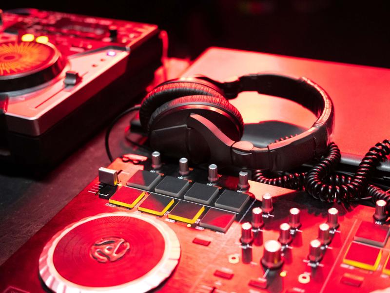 red disc jockey turntable and headphones