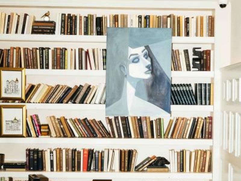 A portrait of a woman hanging in a library