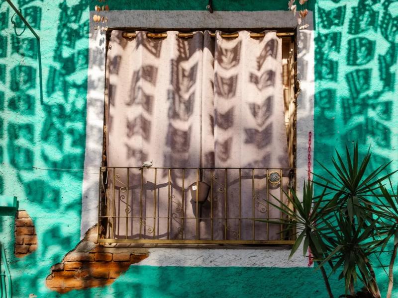 A window on a colorful building in Los Cabos